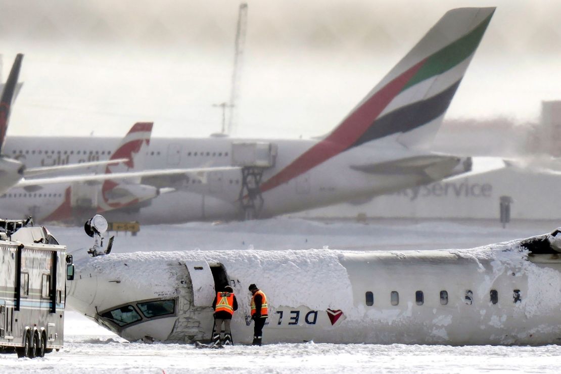 A Delta Air Lines plane lies upside down at Toronto Pearson Airport on February 18.