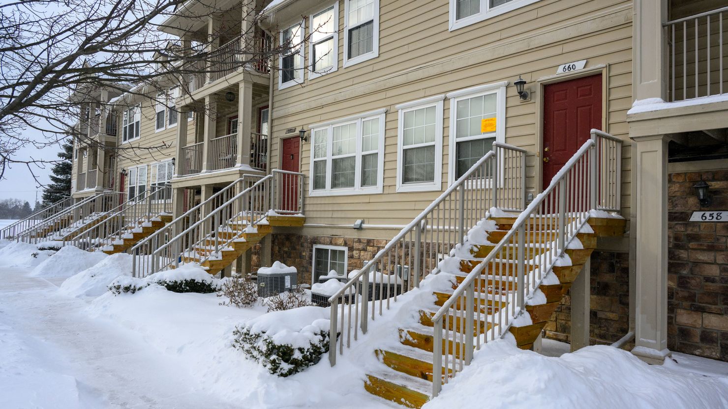 A sign from the City of Pontiac is placed in a window along a row of homes where a mother allegedly left three of her children alone living in squalor.