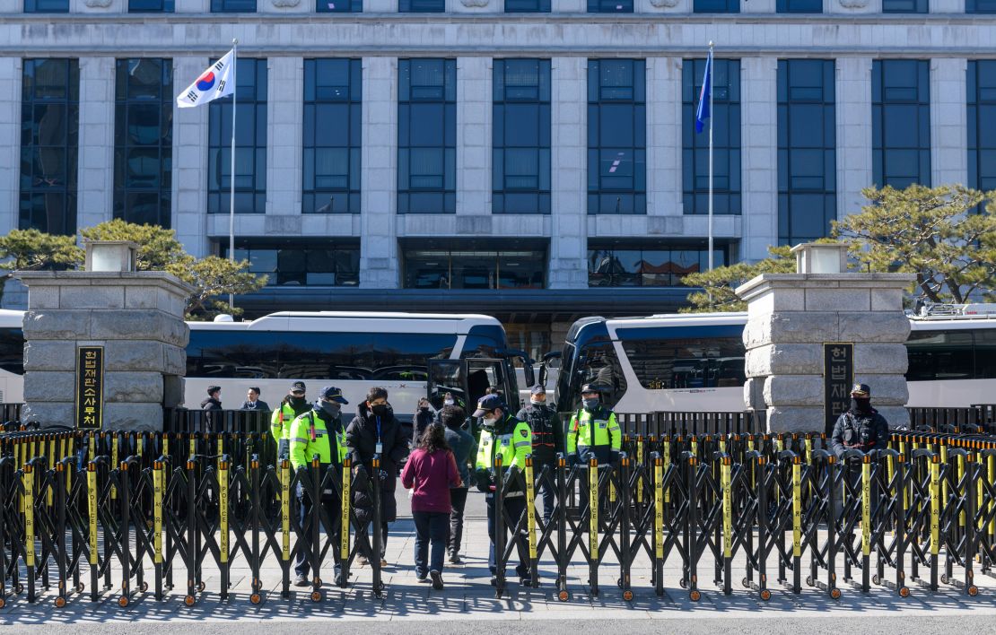 South Korean police officers guard the Constitutional Court in Seoul on Thursday.