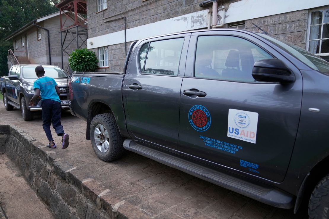 A child runs past USAID-donated vehicles at the Nyumbani Children's Home orphanage in Nairobi on Thursday, Feb. 6, 2025.