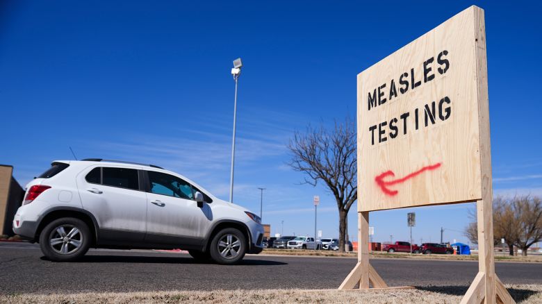 A vehicle drives past a sign outside of Seminole Hospital District offering measles testing Friday, Feb. 21, 2025, in Seminole, Texas. (AP Photo/Julio Cortez)