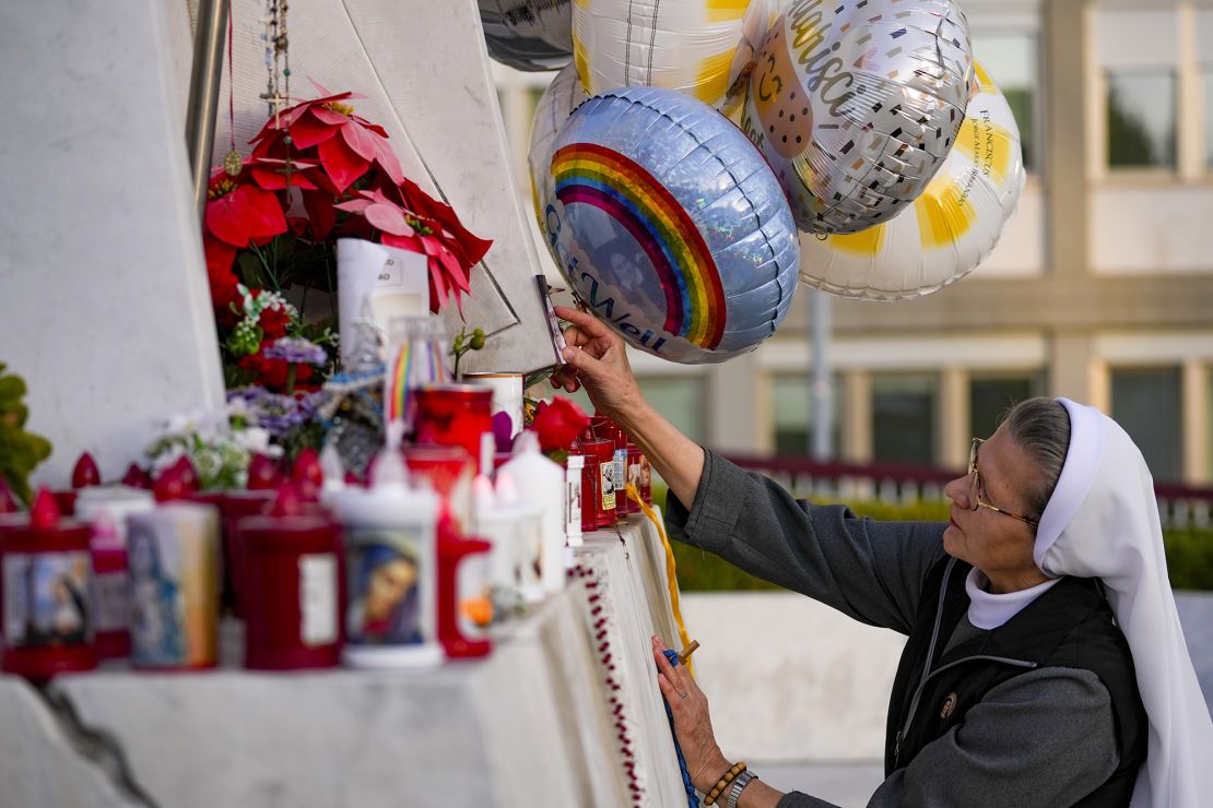 Candles, flowers and balloons have been left at the makeshift shrine.