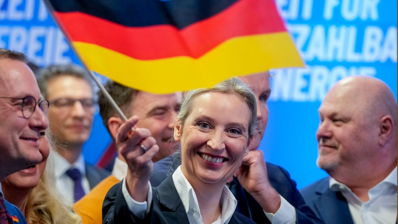AfD co-leader Alice Weidel waves a German flag at the party's headquarters after the elections on Sunday in Berlin.