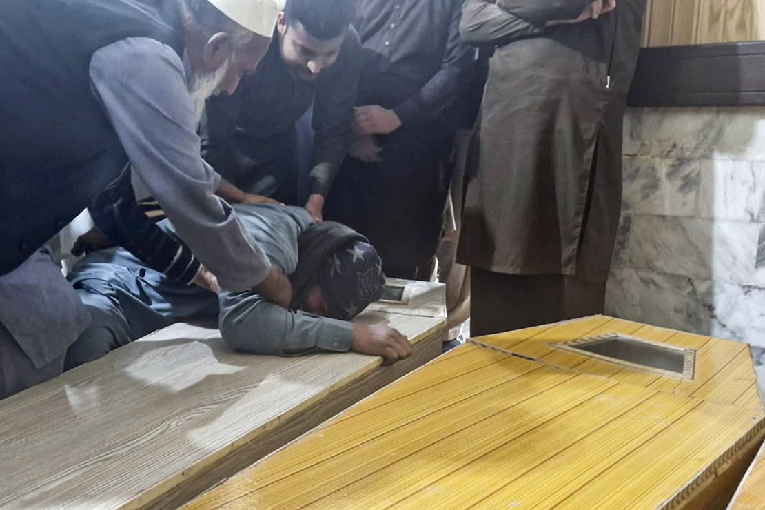 A Pakistani man mourns next to the caskets of the victims of suicide bombing in a mosque within a pro-Taliban seminary, at a hospital in Nowshera, a town in the Pakistan's northwestern Khyber Pakhtunkhwa province, on Friday.