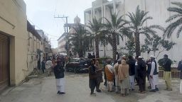 People gather close to the site of bomb exploded in a mosque within a pro-Taliban seminary in Akora Khattak, a district in the Pakistan's northwestern Khyber Pakhtunkhwa province, Friday, Feb. 28, 2025. (AP Photo/Rasool Dawar)