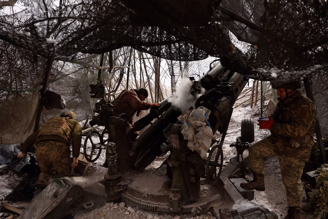 Ukrainian servicemen fire a M777 howitzer towards Russian positions at the frontline near Donetsk, Ukraine, on Sunday.