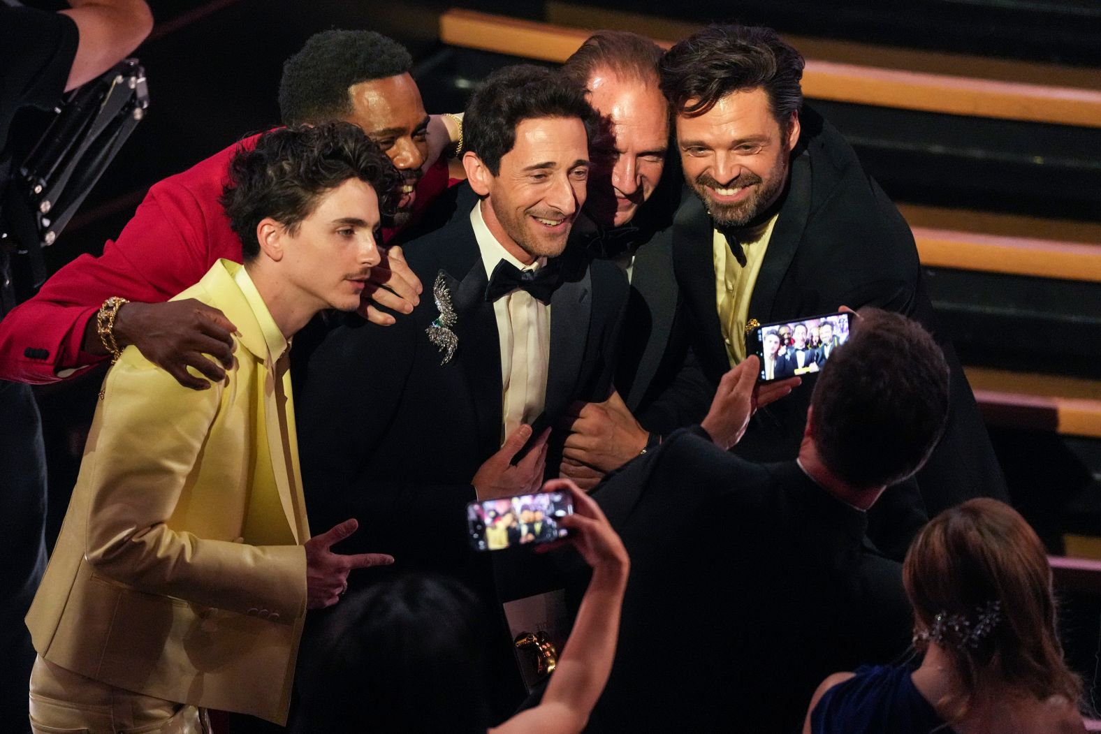 From left, best actor nominees Timothée Chalamet, Colman Domingo, Brody, Ralph Fiennes and Sebastian Stan pose together in the audience.