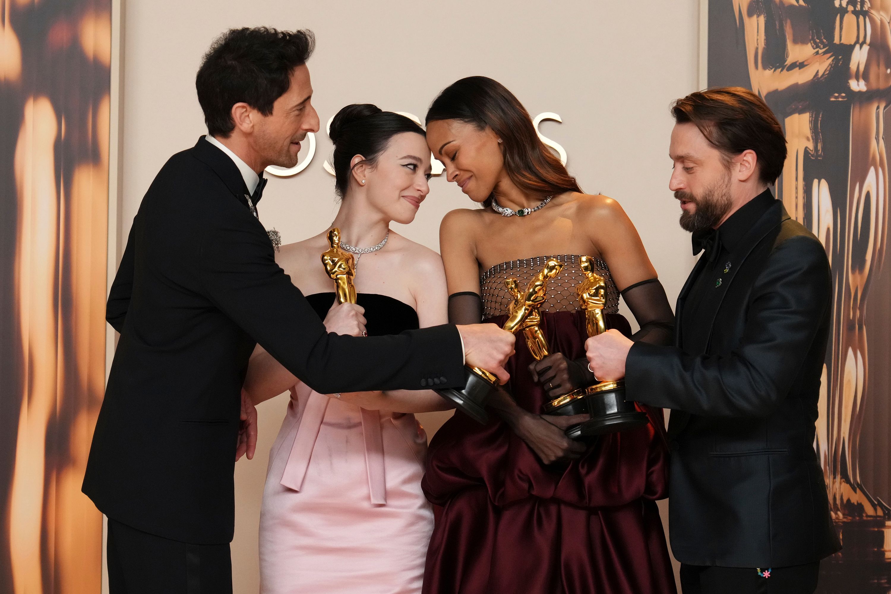 From left, Oscar winners Adrien Brody, Mikey Madison, Zoe Saldaña and Kieran Culkin share a moment together in the Academy Awards press room on Sunday, March 2.