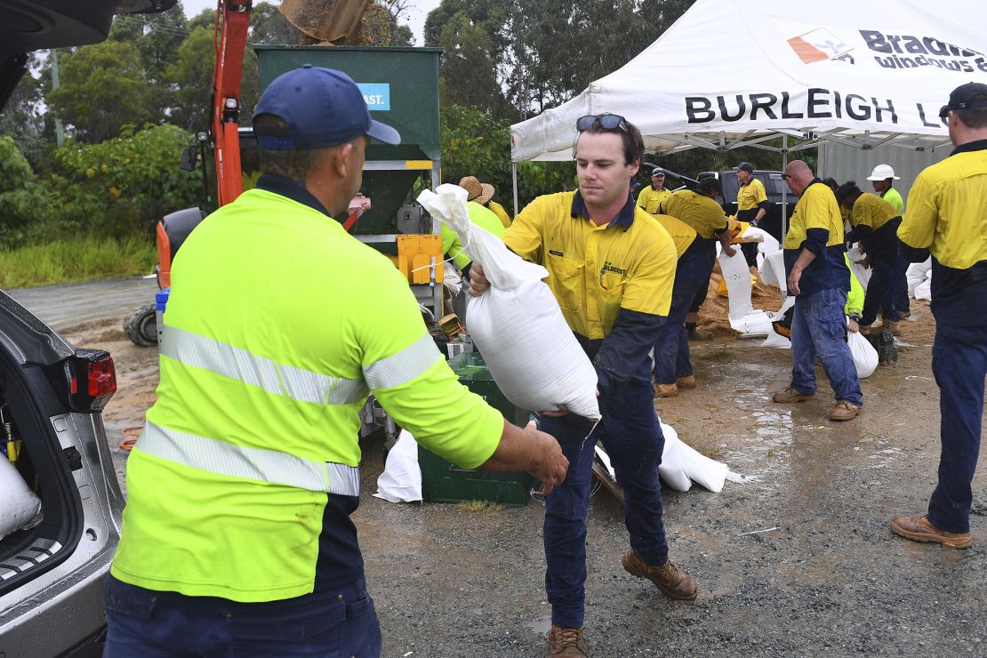 Council workers and residents fill sandbags on the Gold Coast, Australia, Monday, March 3, 2025.