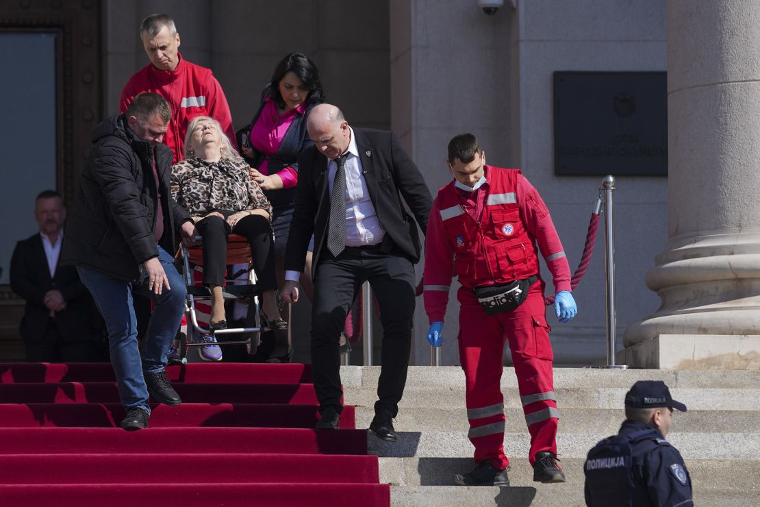 Medics carry a Serbian lawmaker injured after chaos erupted during a parliament session in Belgrade, Serbia on Tuesday.