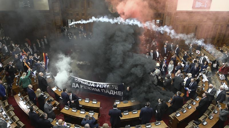 Smoke grenades tossed in Serbian parliament, lawmaker suffers stroke