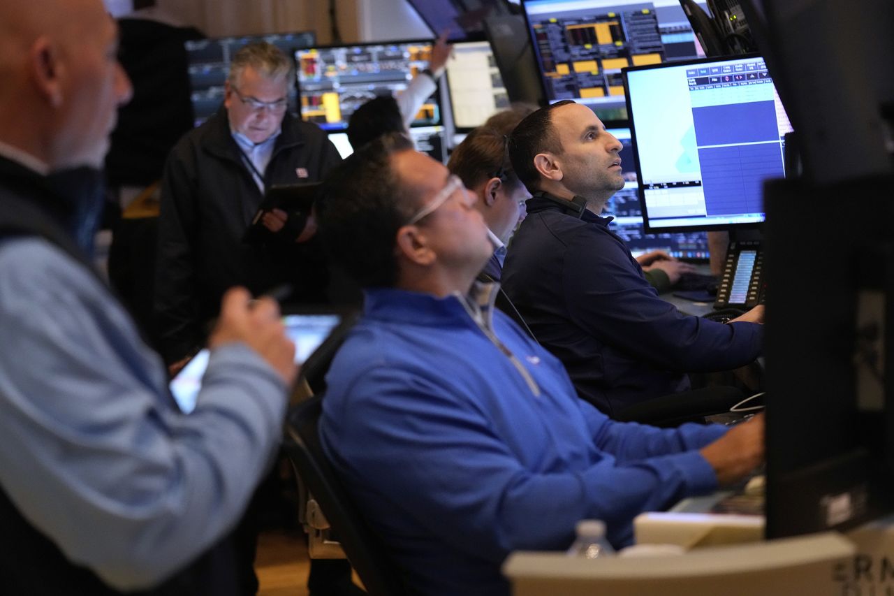 People work on the floor at the New York Stock Exchange on Tuesday.