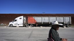 Susano Cordoba, right, sells peanuts to truck drivers lining up to cross the border into the United States as tariffs against Mexico go into effect, Tuesday, March 4, 2025, in Tijuana, Mexico.