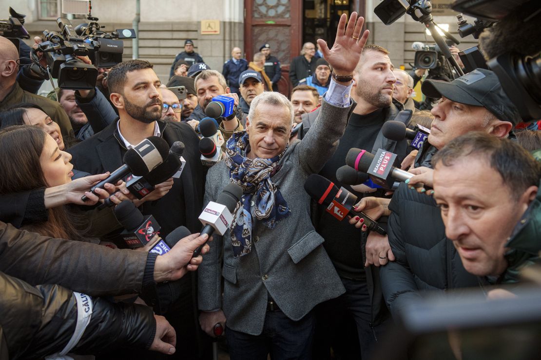 Georgescu rises to supporters after leaving a courtroom in Bucharest, March 5, 2025.