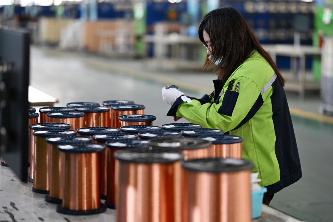 A woman works in a factory making copper-clad aluminum enameled wire in Suqian city in east China's Jiangsu province.