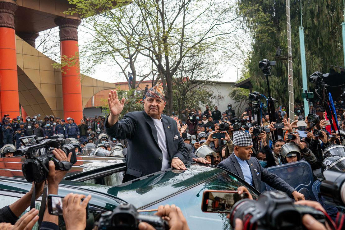 Former King Gyanendra Shah of Nepal waves upon his arrival at Tribhuvan International Airport in Kathmandu, Nepal, on Sunday, March 9, 2025.