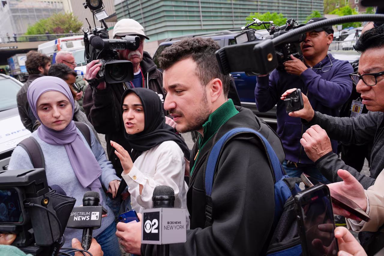 Members of the Columbia University Apartheid Divest group, including Mahmoud Khalil, center, are surrounded by members of the media outside the Columbia University campus on April 30, 2024, in New York.