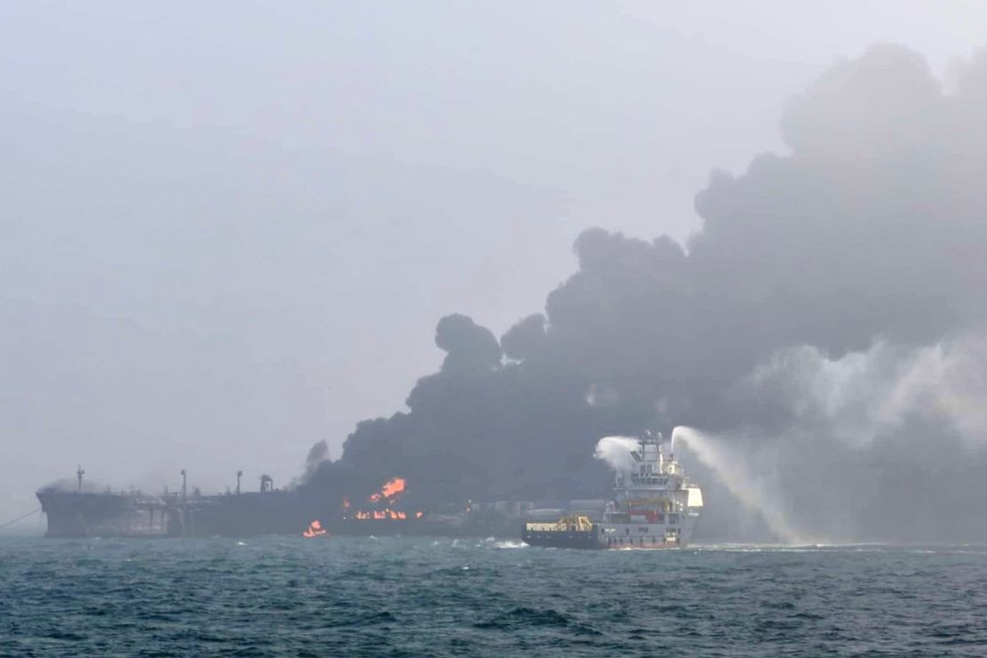 The firefighter is trying to put out the flames after Monday's collision in the North Sea.