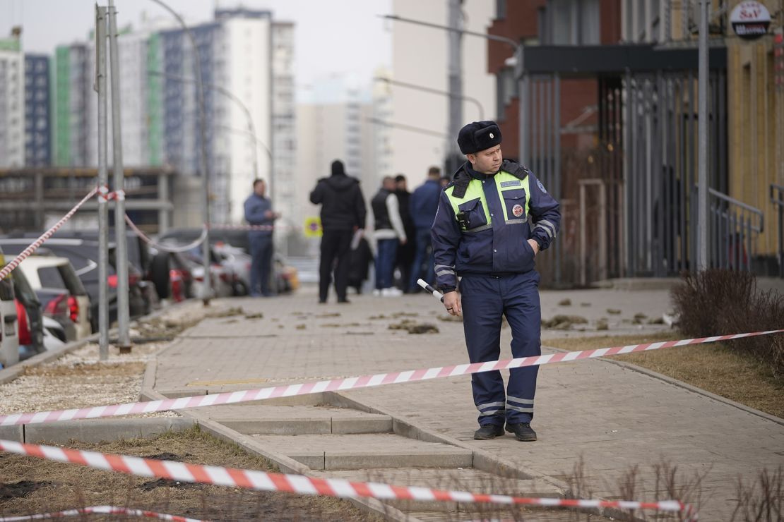 A police officer patrols near an apartment building where a downed Ukrainian drone fell in Sapronovo village outside Moscow, on March 11, 2025.