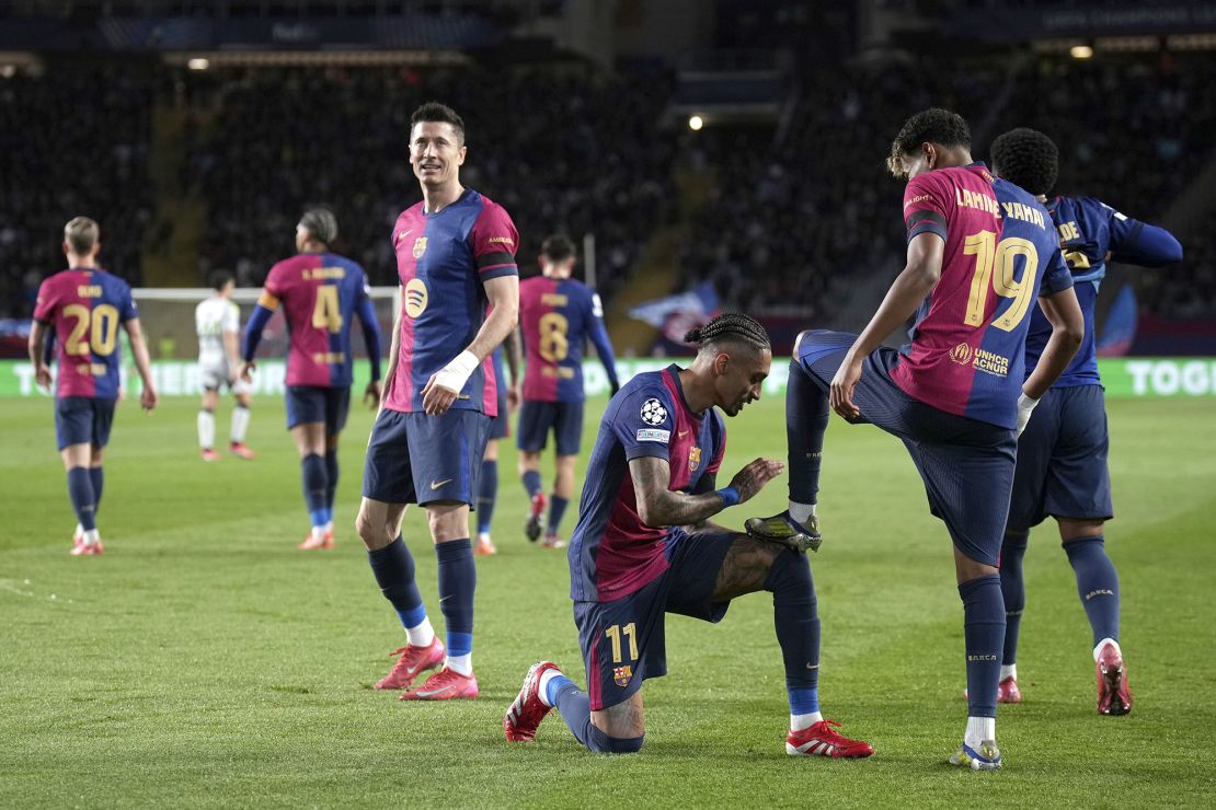 Yamal celebrates with his teammate Raphinha after scoring his side's second goal.