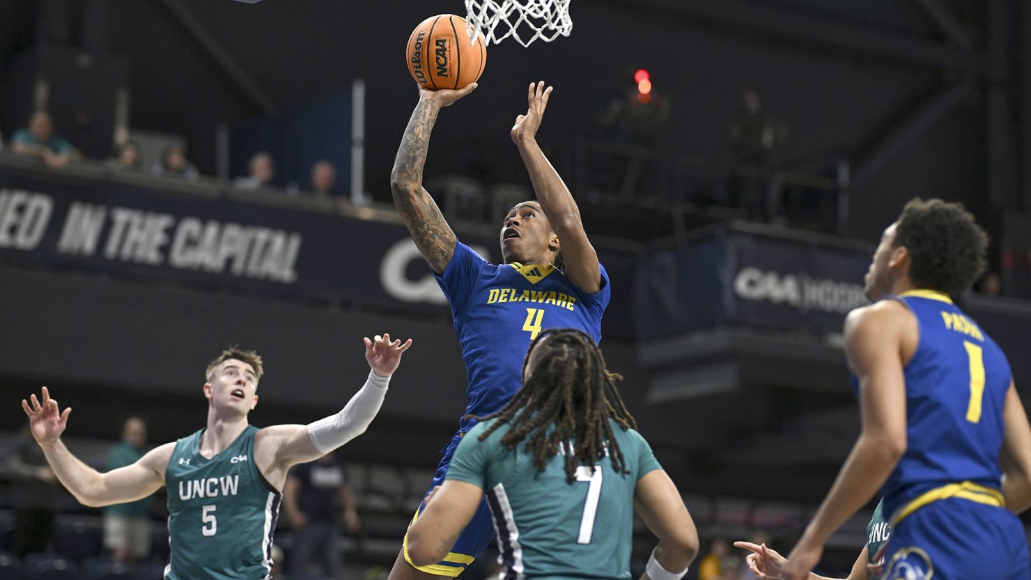 Delaware guard Niels Lane shoots over UNC Wilmington guard Greedy Williams (7) in the first half of the Coastal Athletic Association championship on March 11.