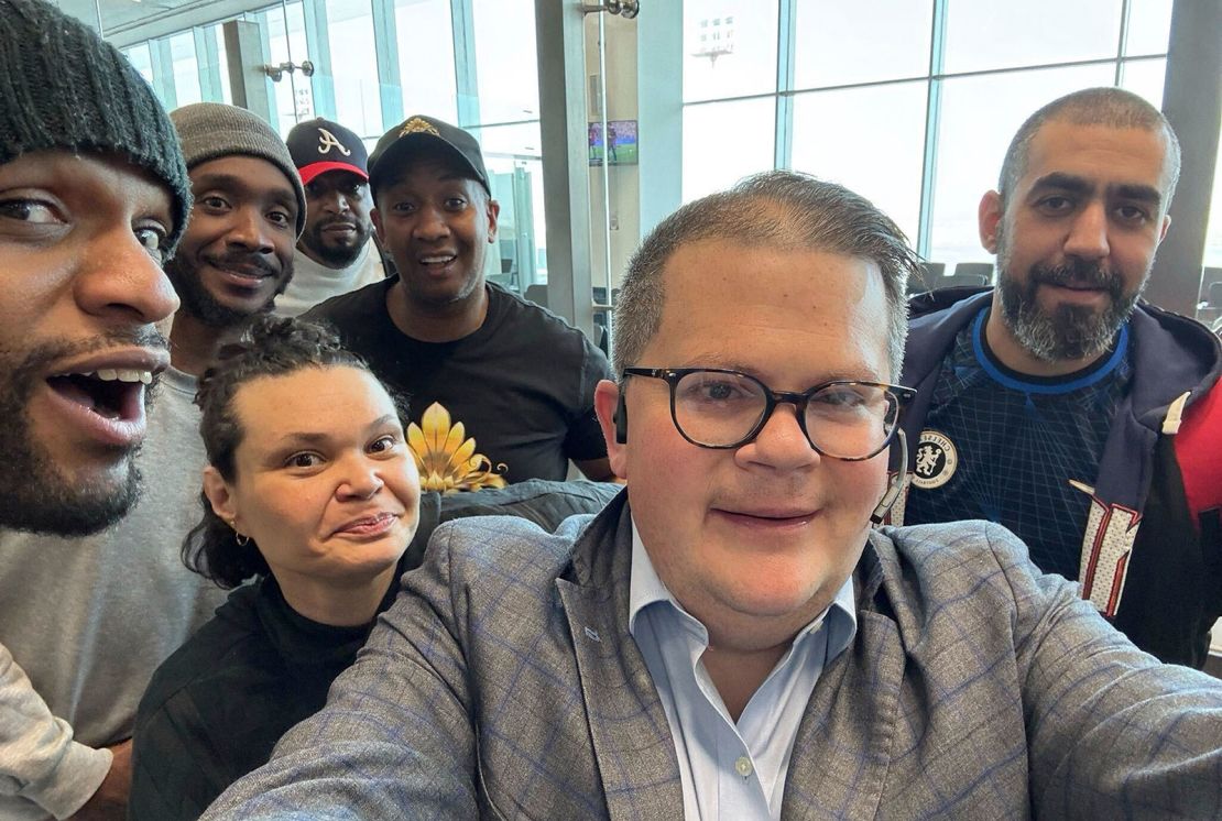 This image provided by Jonathan Franks shows Franks with six American prisoners detained by Kuwait as they pose for a photo at Kuwait International Airport Wednesday, March 12, 2025, before flying home to the United States. Franks is a private consultant who helped work for their release.