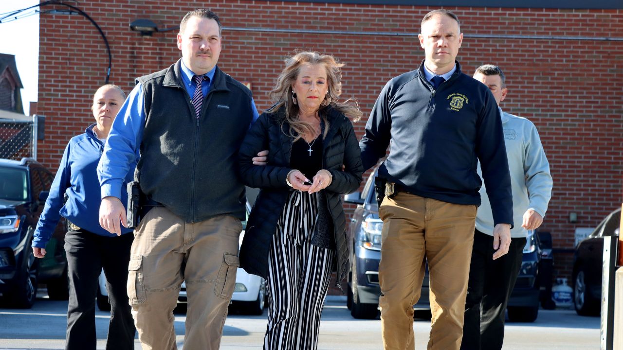 This photo provided by the Waterbury Police Department shows Kimberly Sullivan being taken into custody who was charged Wednesday, March 12, 2025, with kidnapping and cruelty for allegedly holding her 32-year-old stepson captive for more than 20 years. (Waterbury Police Department via AP)