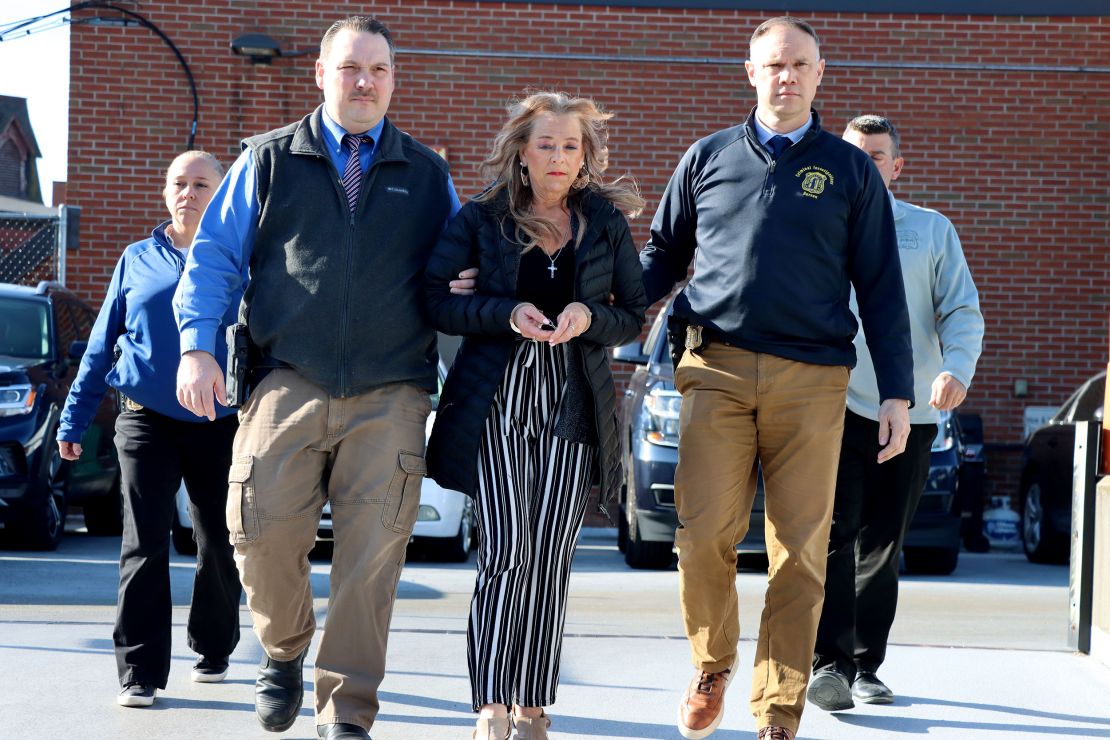 Kimberly Sullivan is taken into custody Wednesday.
