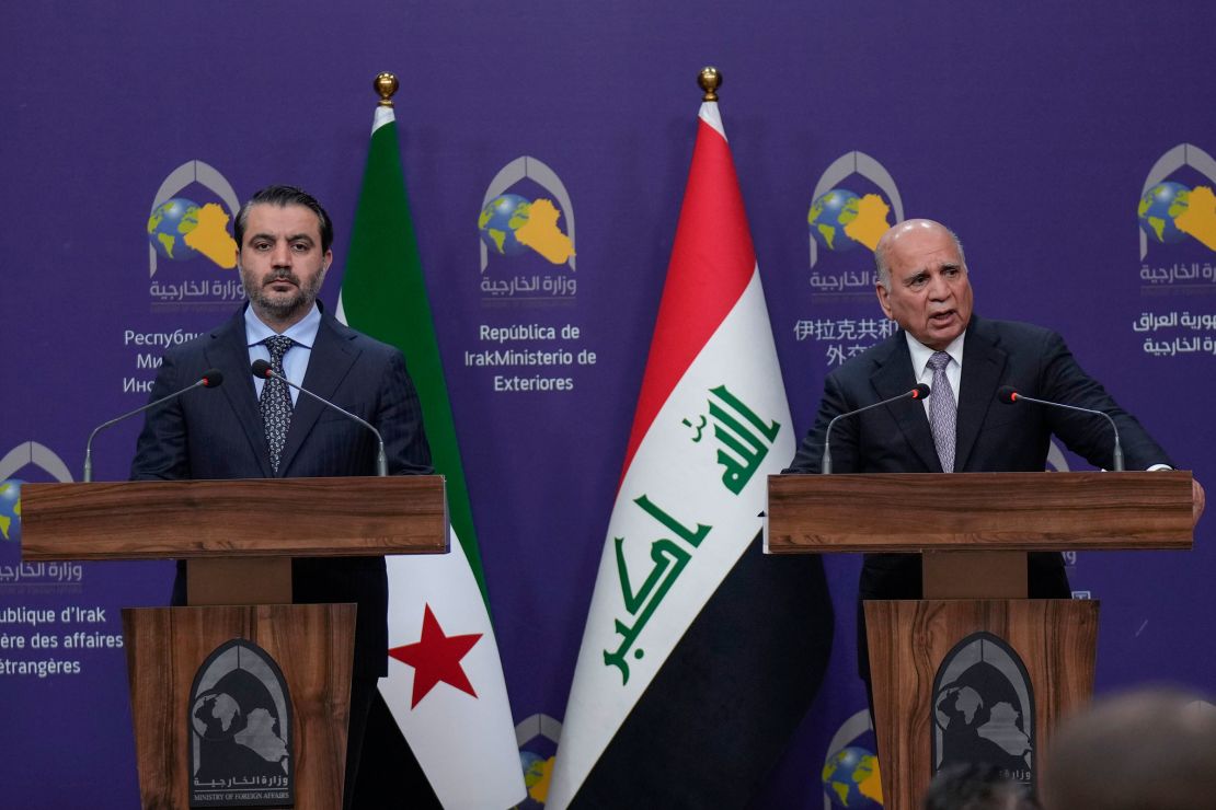 Iraqi Foreign Minister Fouad Hussein, right, speaks during a news conference with his Syrian counterpart Asaad Hassan al-Shibani, following their meeting in Baghdad, Iraq, on Friday, March14, 2025.