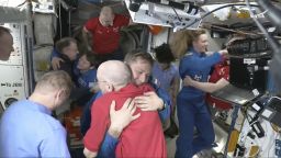 This image made from video by NASA shows astronauts Don Pettit, bottom center, hugging Kirill Peskov as astronauts greet each other after a SpaceX capsule docked with the International Space Station, Sunday, March 16, 2025. (NASA via AP)
