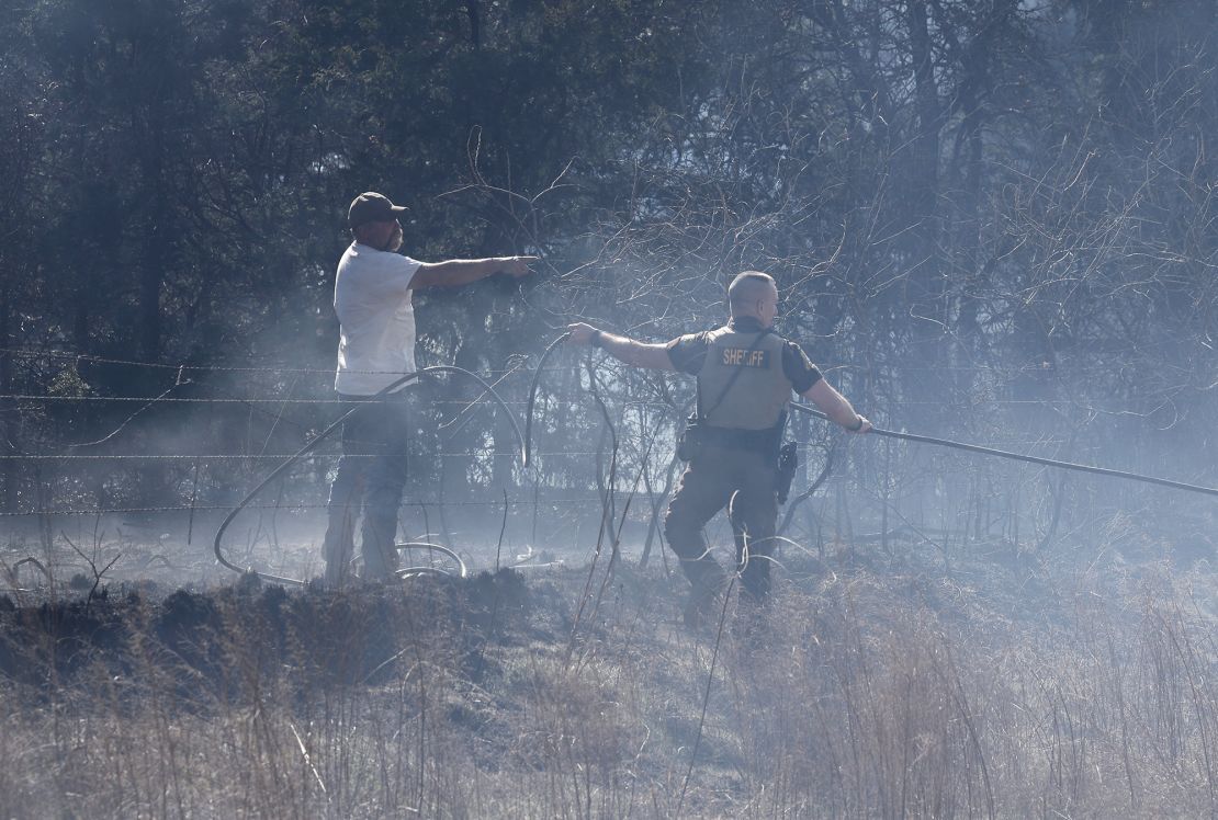Fire crews, volunteers and the Payne County Sheriff's office battle hot spots and new fires several miles west of Stillwater, Oklahoma on Monday.