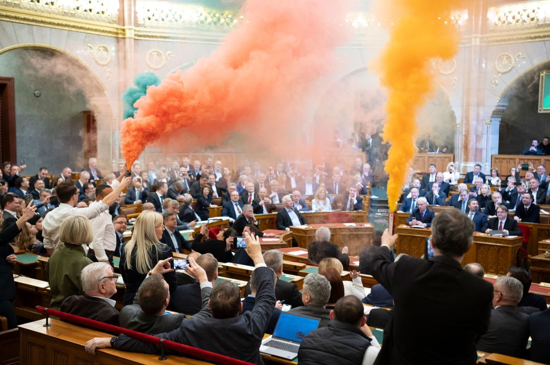 Rainbow-colored smoke bombs were set off by legislators as the anti-LGBTQ+ law was passed inside Hungary's parliament in Budapest on Tuesday, March 18.