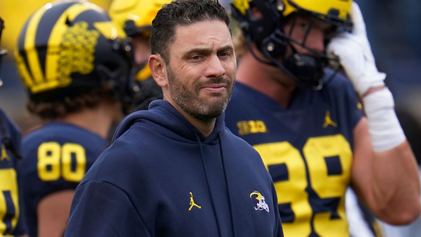 Former Michigan coach Matt Weiss was charged with 14 counts of unauthorized computer access and 10 counts of identity theft, according to an indictment filed Thursday. Paul Sancya/AP/File