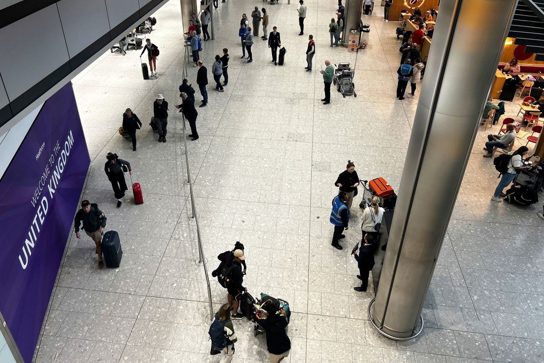 Travelers arrive at Heathrow Airport's Terminal 5 on Saturday.