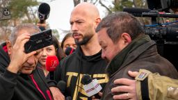 Andrew Tate (center), a self-proclaimed misogynist, and his brother, arrived at a police station in Bucharest on March 24, to register with authorities as part of a human trafficking investigation.