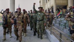 Sudan's military chief Gen. Abdel-Fattah Burhan center, is greeted by troops as he arrives at the Republican Palace, recently recaptured from the Rapid Support Forces paramilitary group, in Khartoum, Sudan, on Wednesday, March 26, 2025.