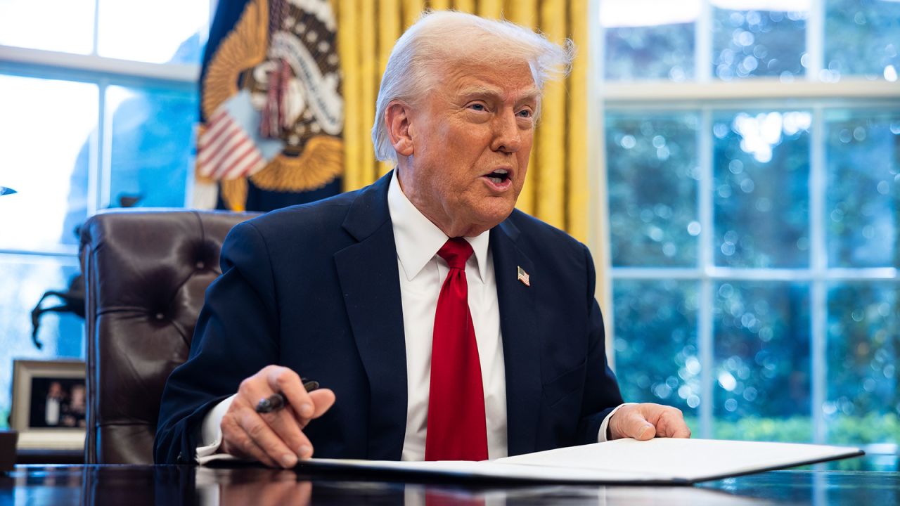 President Donald Trump signs an executive order on auto tariffs in the Oval Office at the White House March 26, 2025.