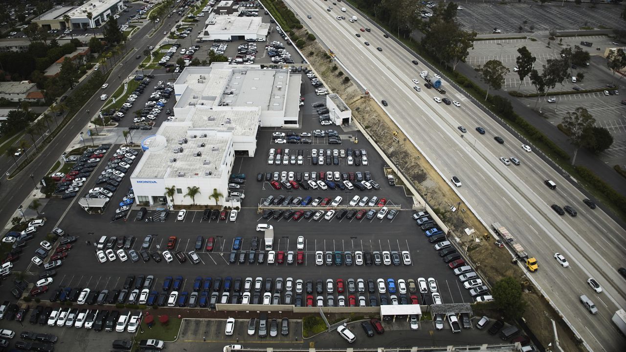 An aerial view shows auto dealerships in Cerritos, Calif., Thursday, March 27, 2025. (AP Photo/Jae C. Hong)