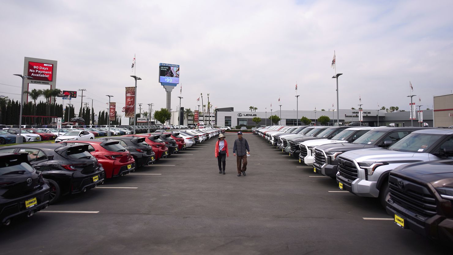 Two people shop at a Toyota dealership in El Monte, Calif., Thursday, March 27, 2025.