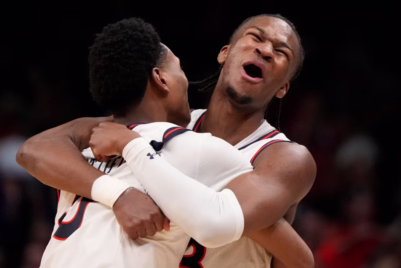 Auburn's Tahaad Pettiford, left, and Miles Kelly celebrate a 70-64 win over Michigan State in Atlanta on Sunday.
