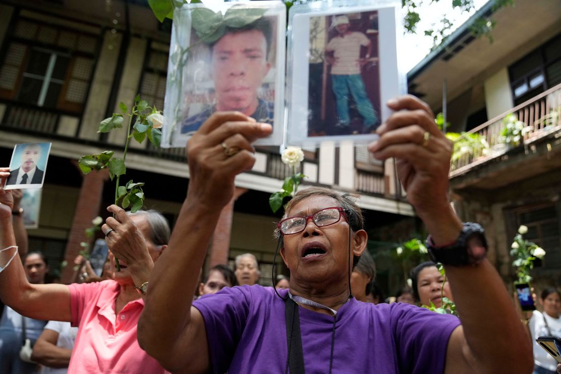 Families of victims of Duterte's "war on drugs" raise flowers and pictures of relatives during a thanksgiving Mass in Quezon City, Philippines, March 31, 2025.