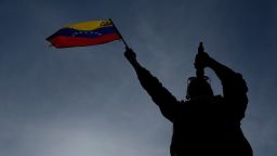 Un hombre sosteniendo una bandera venezolana canta en una manifestación organizada por el gobierno contra las deportaciones de EE.UU. en Caracas, Venezuela, el 2 de abril.
