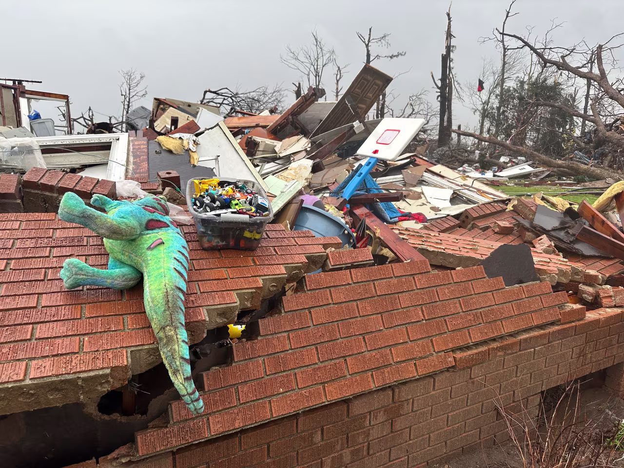 Debris covers a home in Lake City, Arkansas, on Thursday.