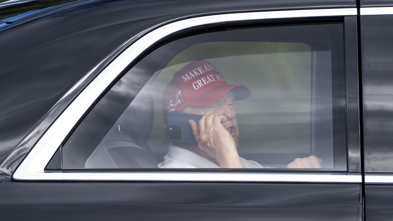 President Donald Trump talks on the phone as he arrives at the Trump International Golf Club, Friday, April 4, 2025, in West Palm Beach, Fla. (AP Photo/Alex Brandon)
