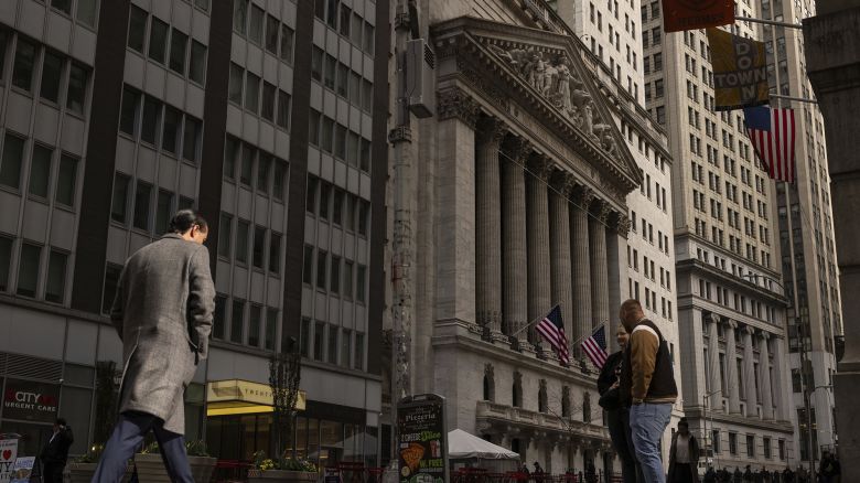 People walk past the New York Stock Exchange, Thursday, April 10, 2025, in New York. (AP Photo/Yuki Iwamura)