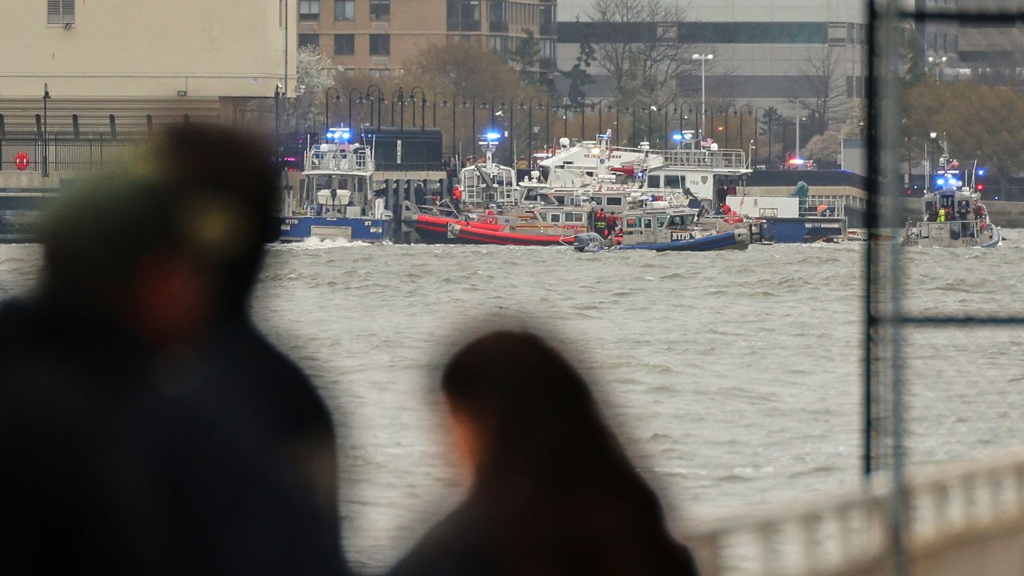 Police and fire crews from New York and New Jersey respond to the scene Thursday where a helicopter went down in the Hudson River.
