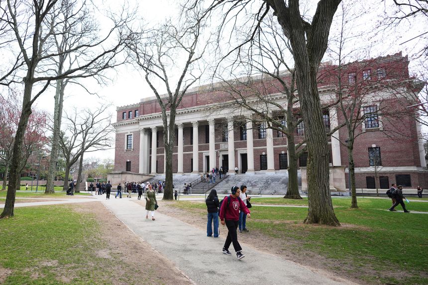 Pedestrians walk in April past the Widener Library at Harvard University in Cambridge, Massachusetts.