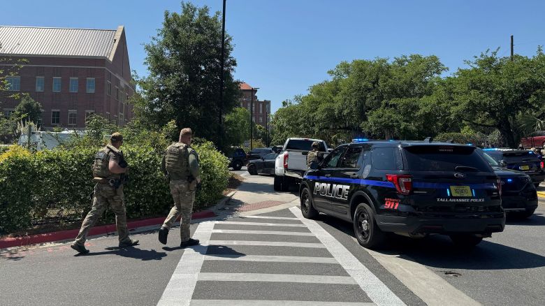 Dozens of patrol vehicles, including a forensics van, are stationed outside of Florida State University’s student union building, the scene of a shooting, Thursday, April 17, 2025, in Tallahassee, Fla. (AP Photo/Kate Payne)