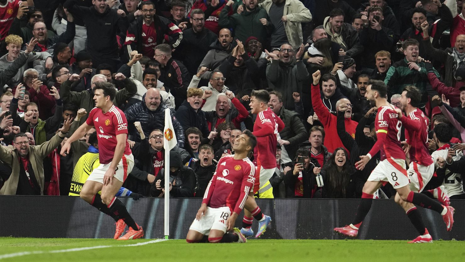 Manchester United players celebrate Harry Maguire's winning goal against Lyon.