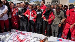 Mourners gather around the bodies of 8 Red Crescent emergency responders recovered in Rafah a week after an Israeli attack.